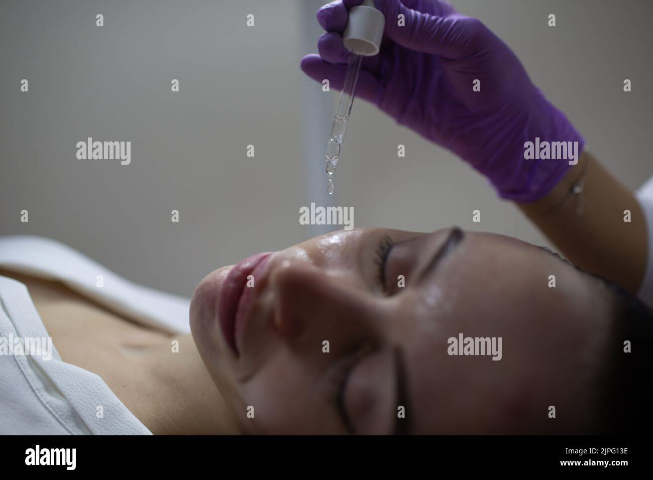 Facial acid peeling mask with retinol and fruit acids in beauty spa salon, Stock Photo