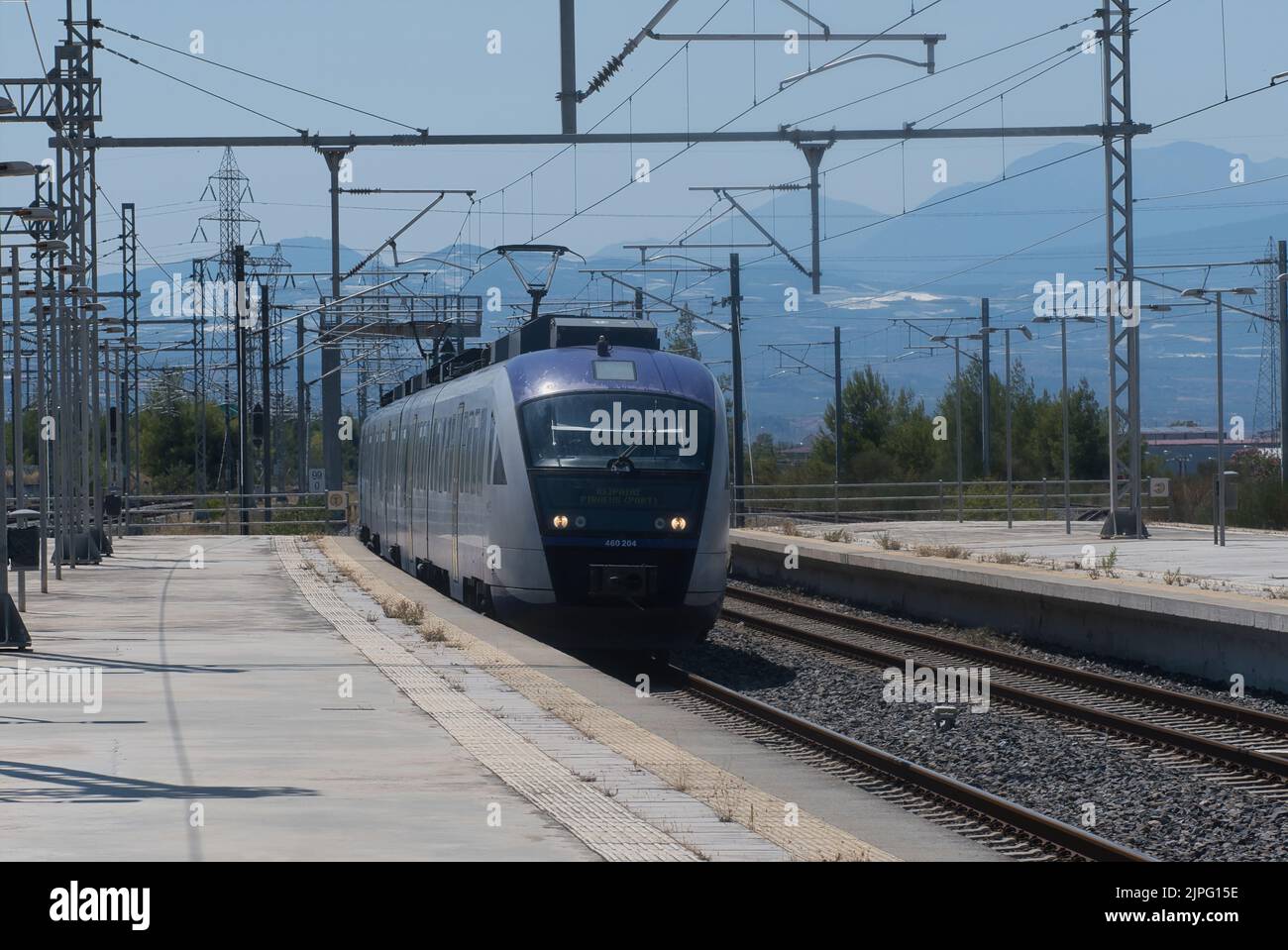 One of the few trains in Greece arriving at Corinth station in Summer Stock Photo