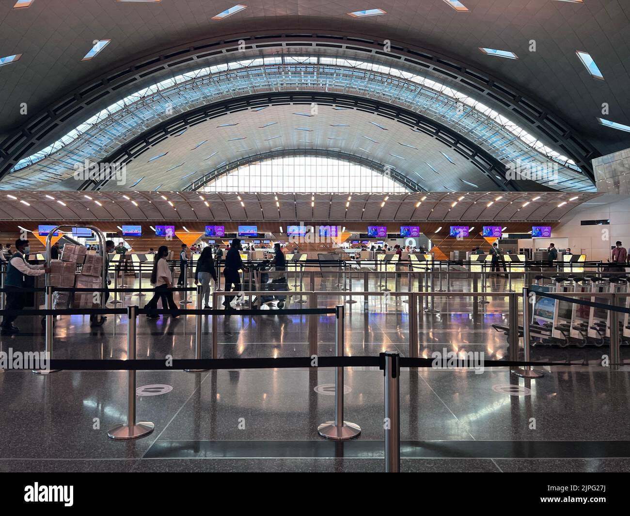 Hamad Terminal Interior of Hamad International Airport Terminal full of Tourist People ...