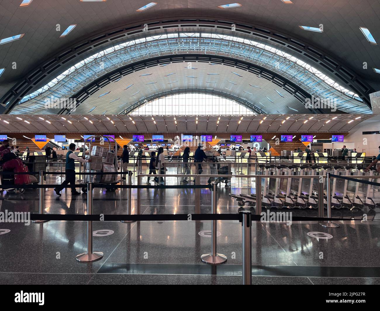 Hamad Terminal Interior of Hamad International Airport Terminal full of Tourist People ...