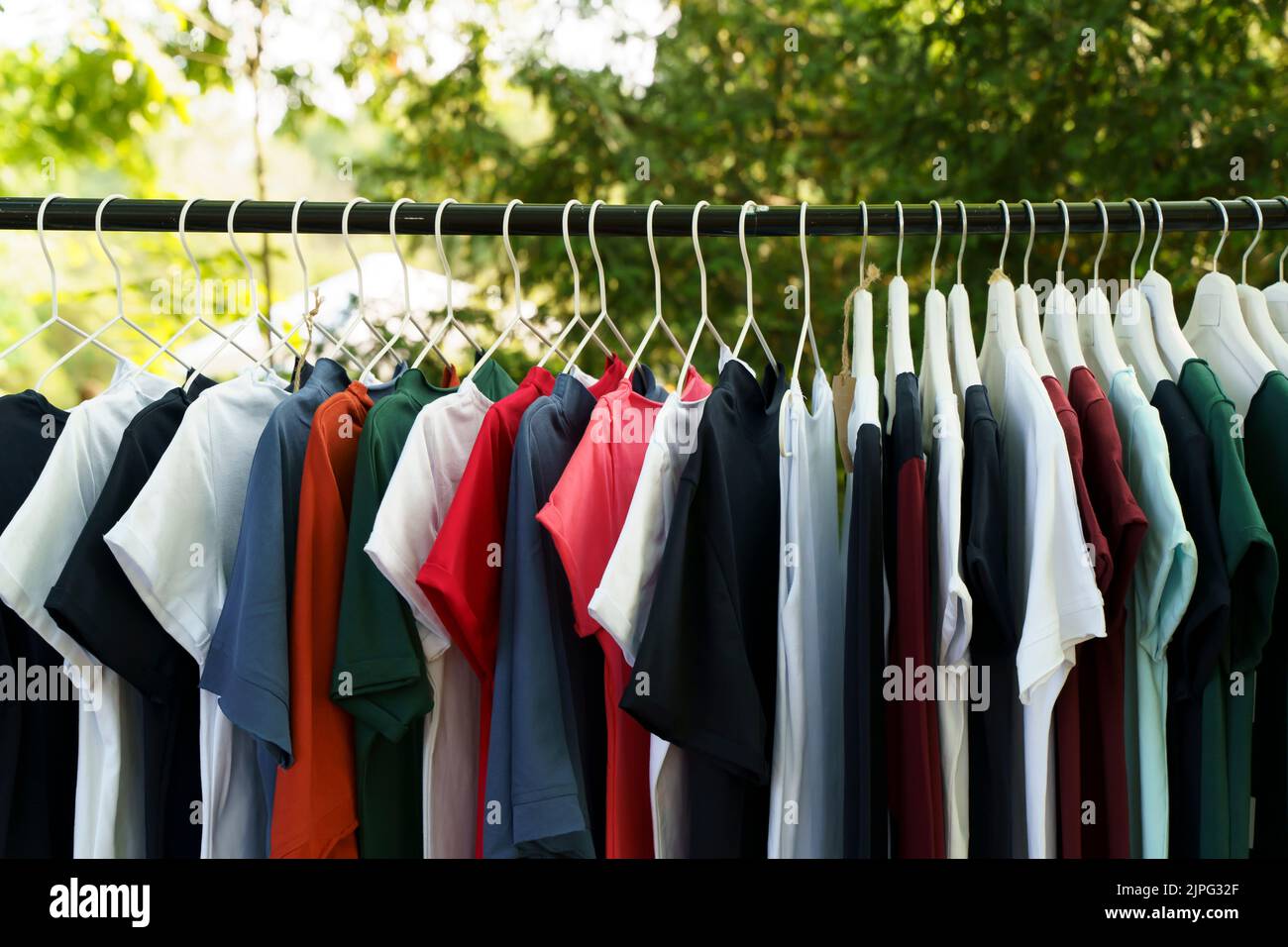 https://c8.alamy.com/comp/2JPG32F/colored-clothes-t-shirts-on-hangers-in-the-market-high-quality-photo-2JPG32F.jpg