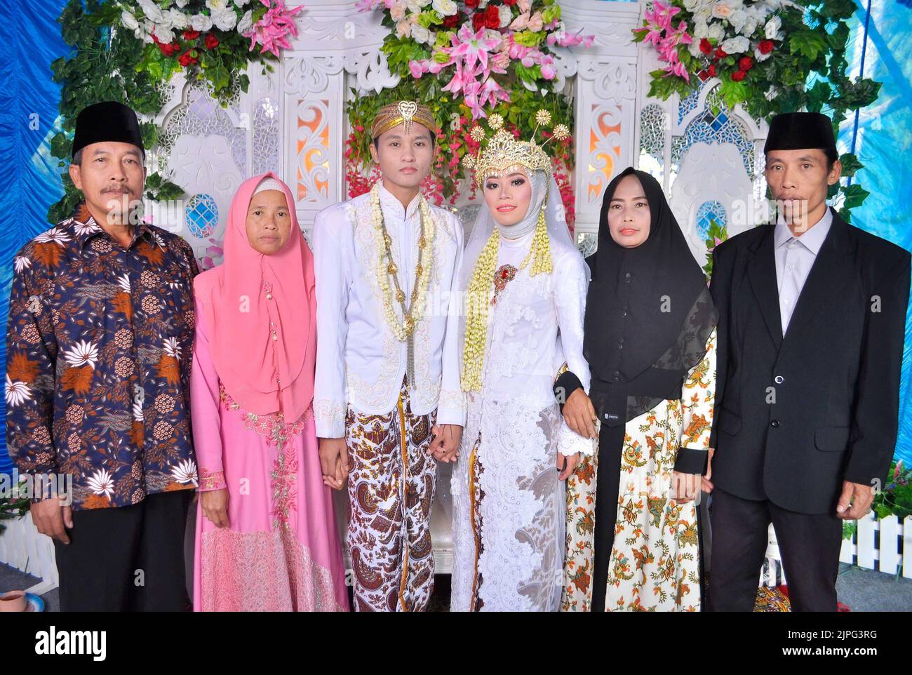 Tegal, INDONESIA - July 19, 2020: The bride and groom with their families. Stock Photo