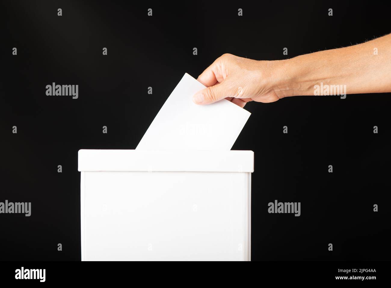 Democracy concept, Caucasian white woman hand putting blank ballot in box Stock Photo