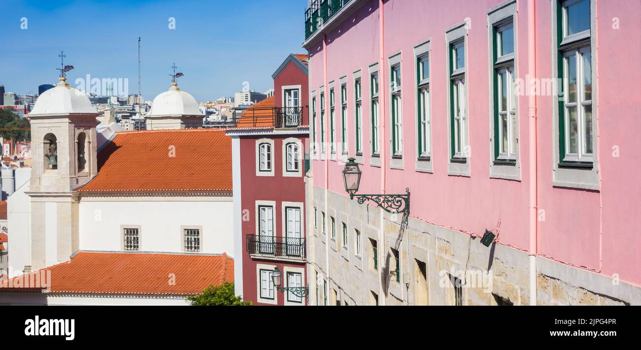 Colorful houses and a white church in Lisbon, Portugal Stock Photo