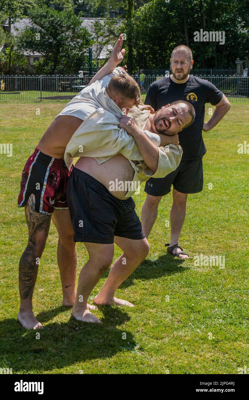 Coaches teaching the rules and techniques of Cornish Wrestling before the start of the Grand Cornish Wrestling Tournament on the picturesque village g Stock Photo