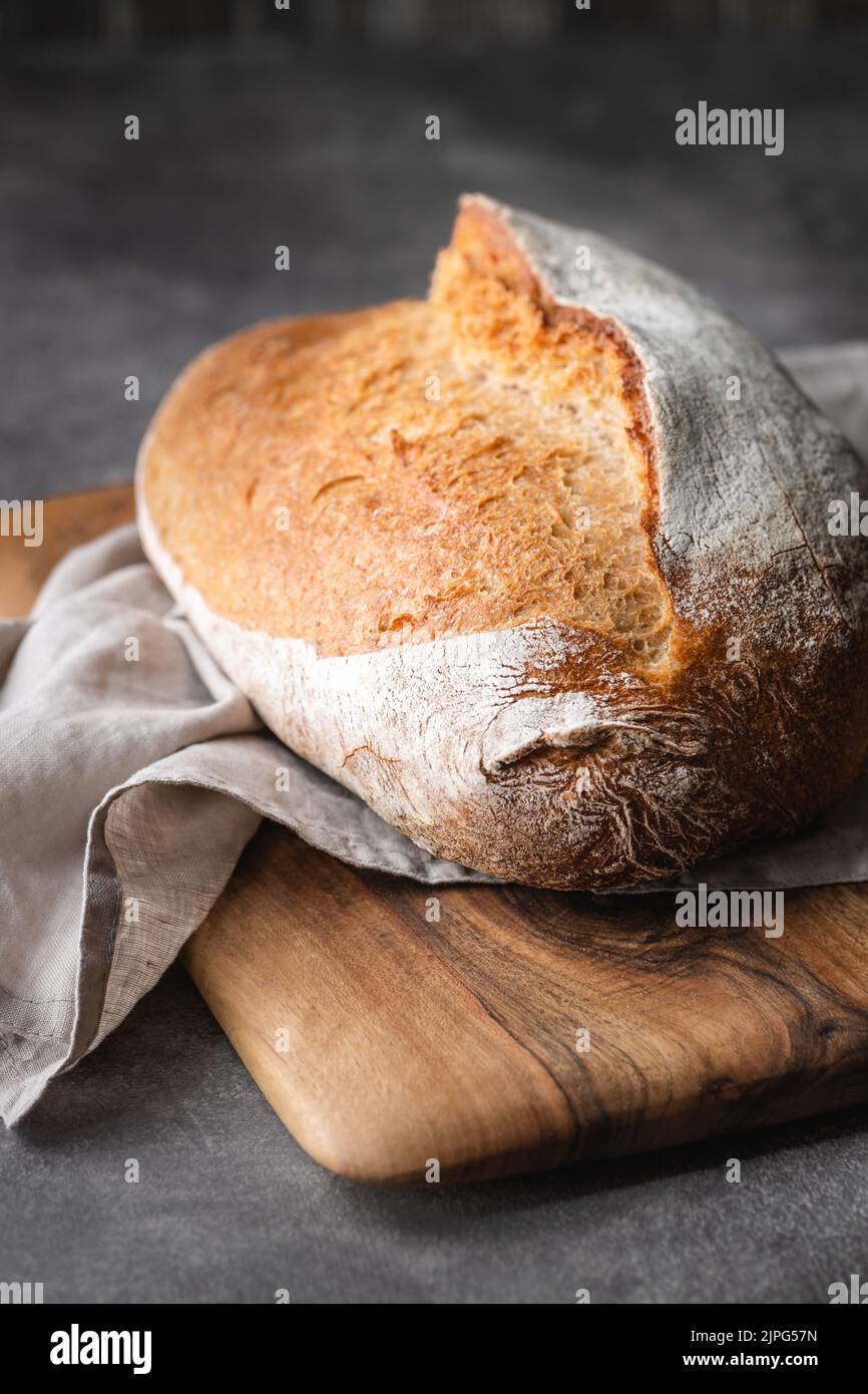 Loaf of sourdough bread on cutting board. Top view. Stock Photo