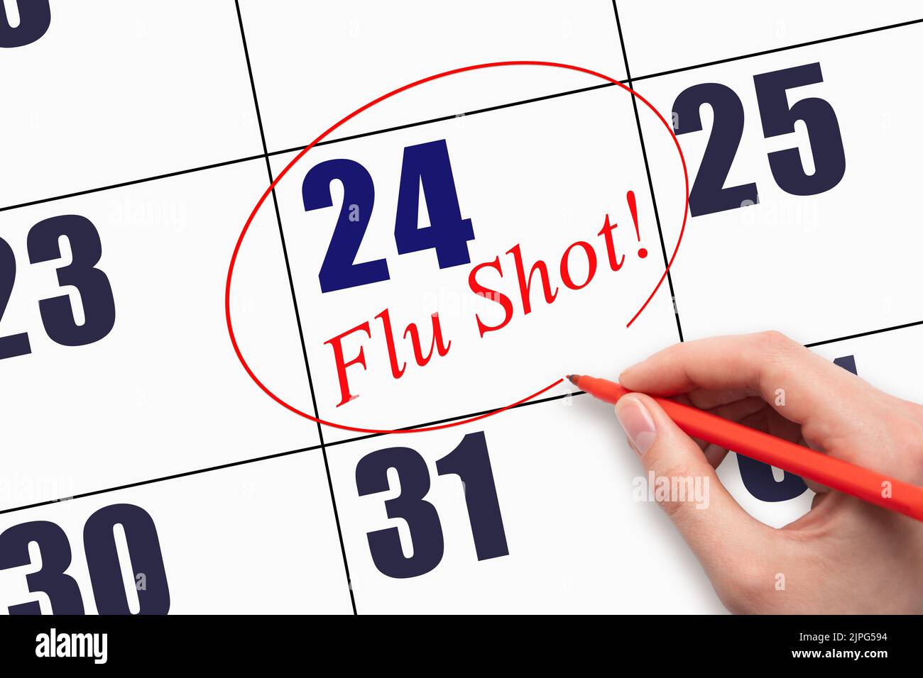 24th day of the month.  Hand writing text FLU SHOT and circling the calendar date. Mark the date on the day planner to have a flu shot. Healthcare Med Stock Photo