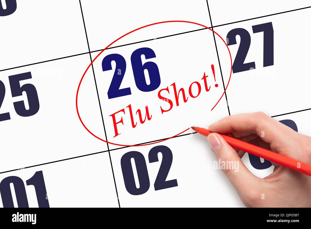 26th day of the month.  Hand writing text FLU SHOT and circling the calendar date. Mark the date on the day planner to have a flu shot. Healthcare Med Stock Photo