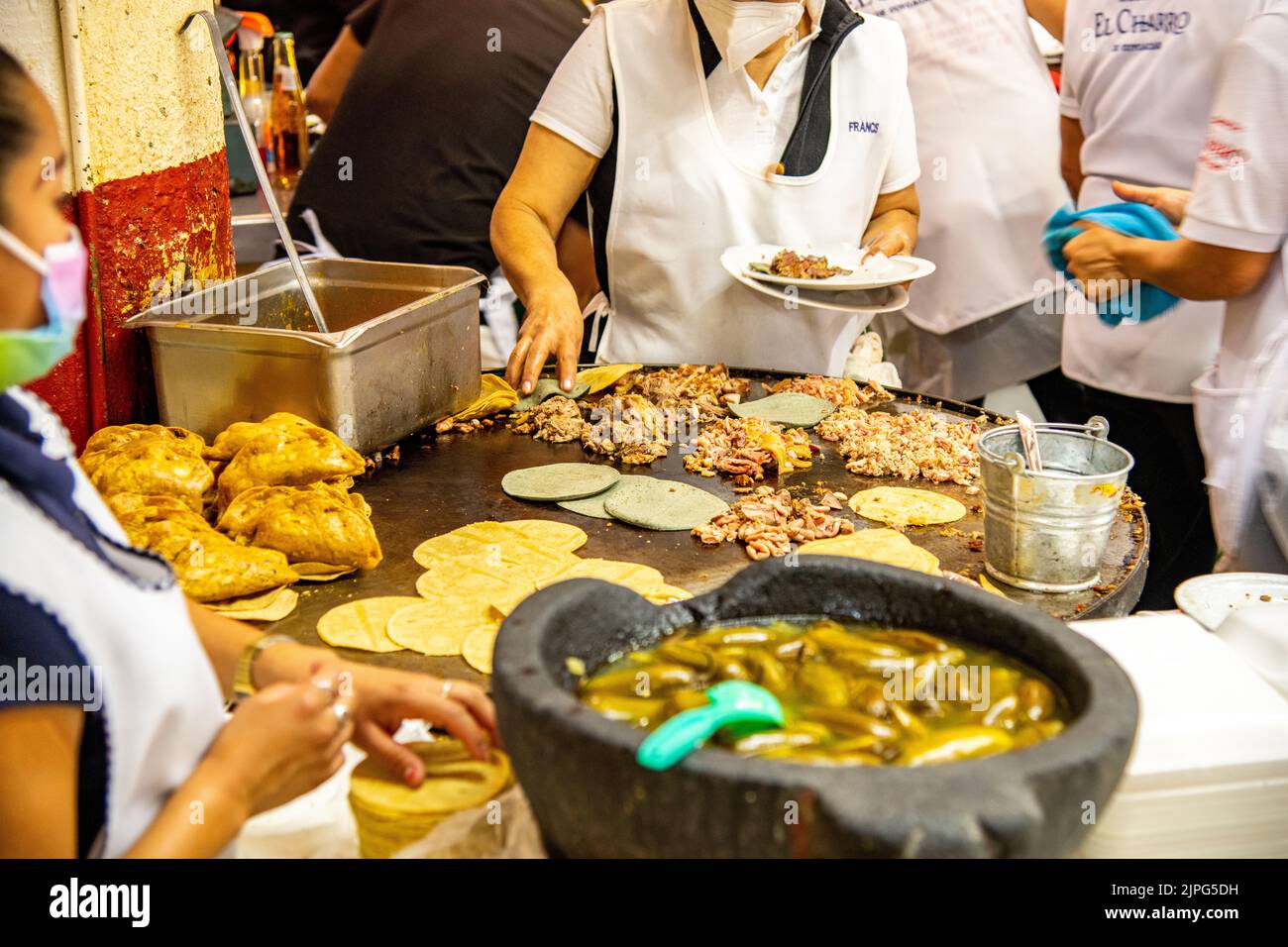 Mexican people cooking and preparing tacos at Coyoacan Market in Mexico City, Mexico Stock Photo