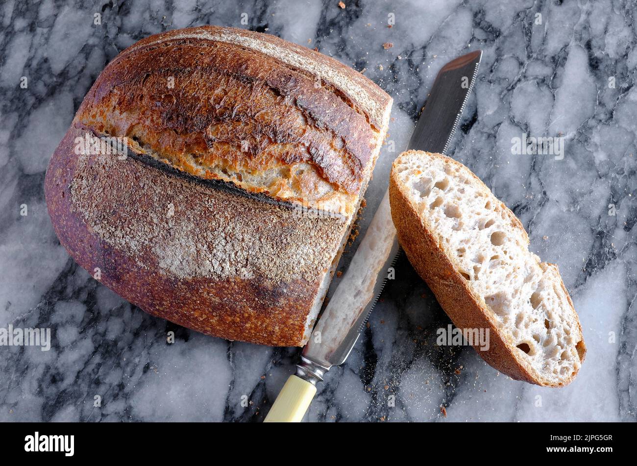artisan sourdough bread on marble table top Stock Photo