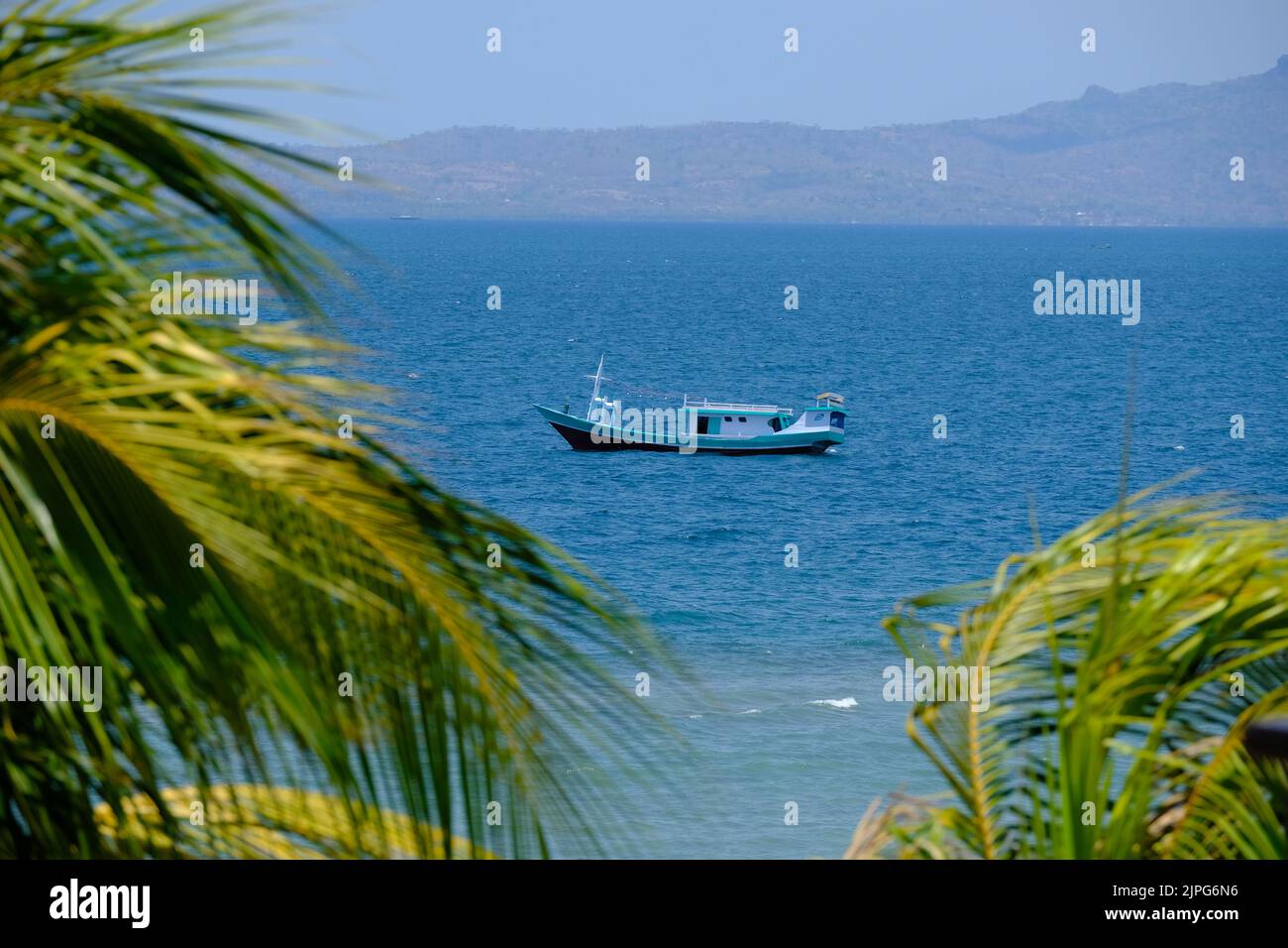 Indonesia Kupang - Coastline  seascape with traditional fishing boat lie at anchor Stock Photo