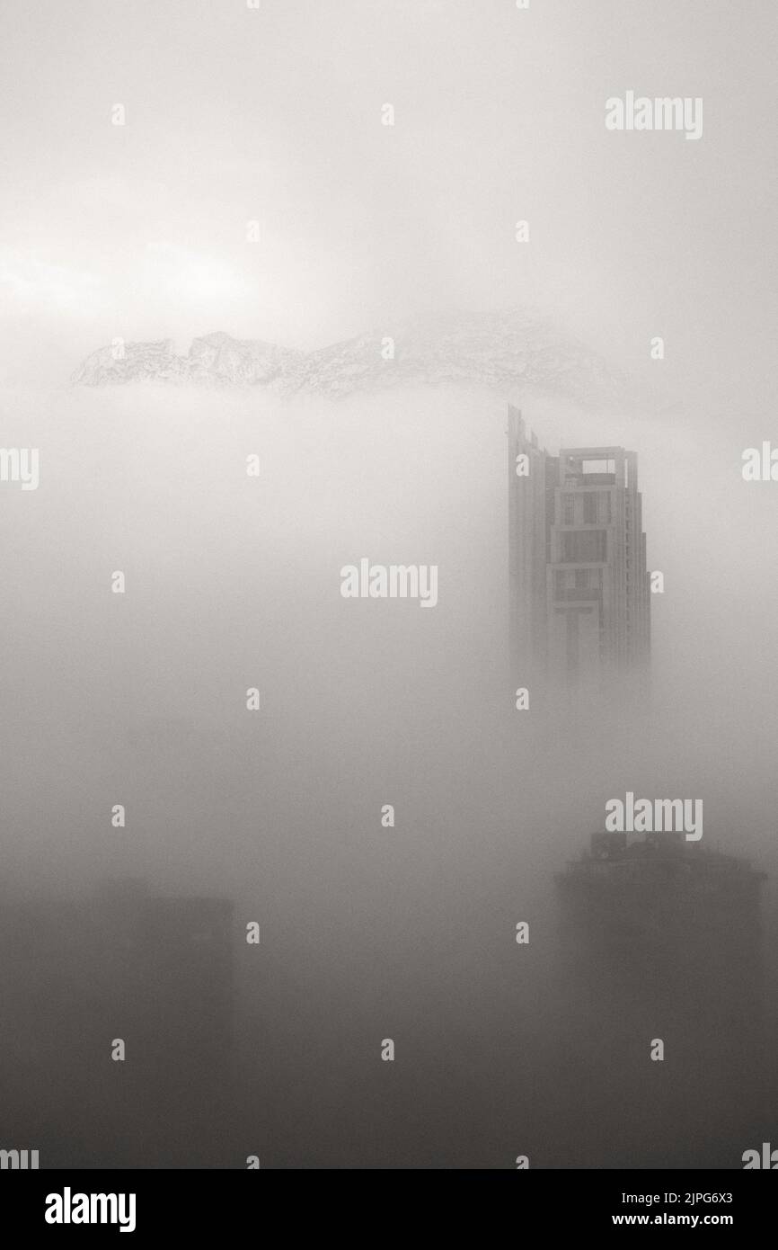 The top of the skyscraper Hotel Bali rises out of the fog in Benidorm, Spain Stock Photo