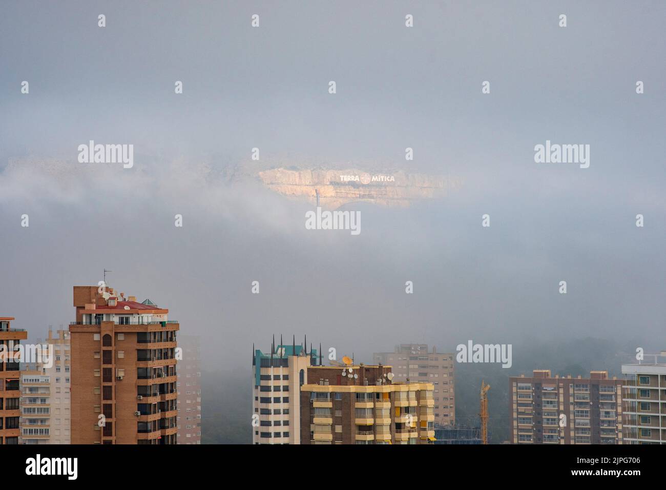 Lettering of the Terra Mitica amusement park shows through the fog over Benidorm, Spain Stock Photo