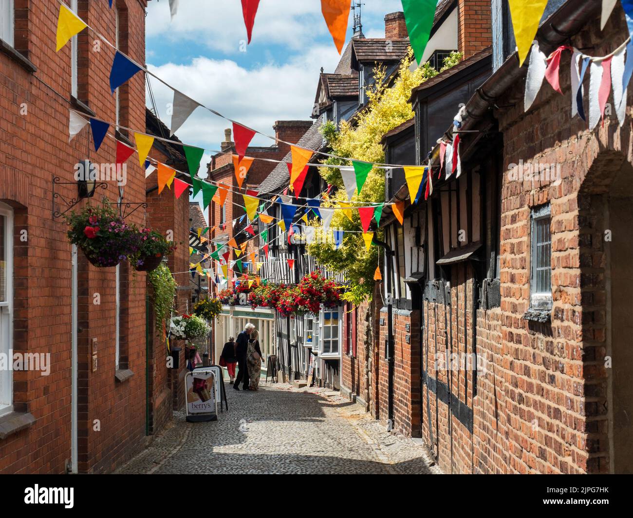 Bunting over Church Lane old cobbled street in Ledbury Herefordshire England Stock Photo