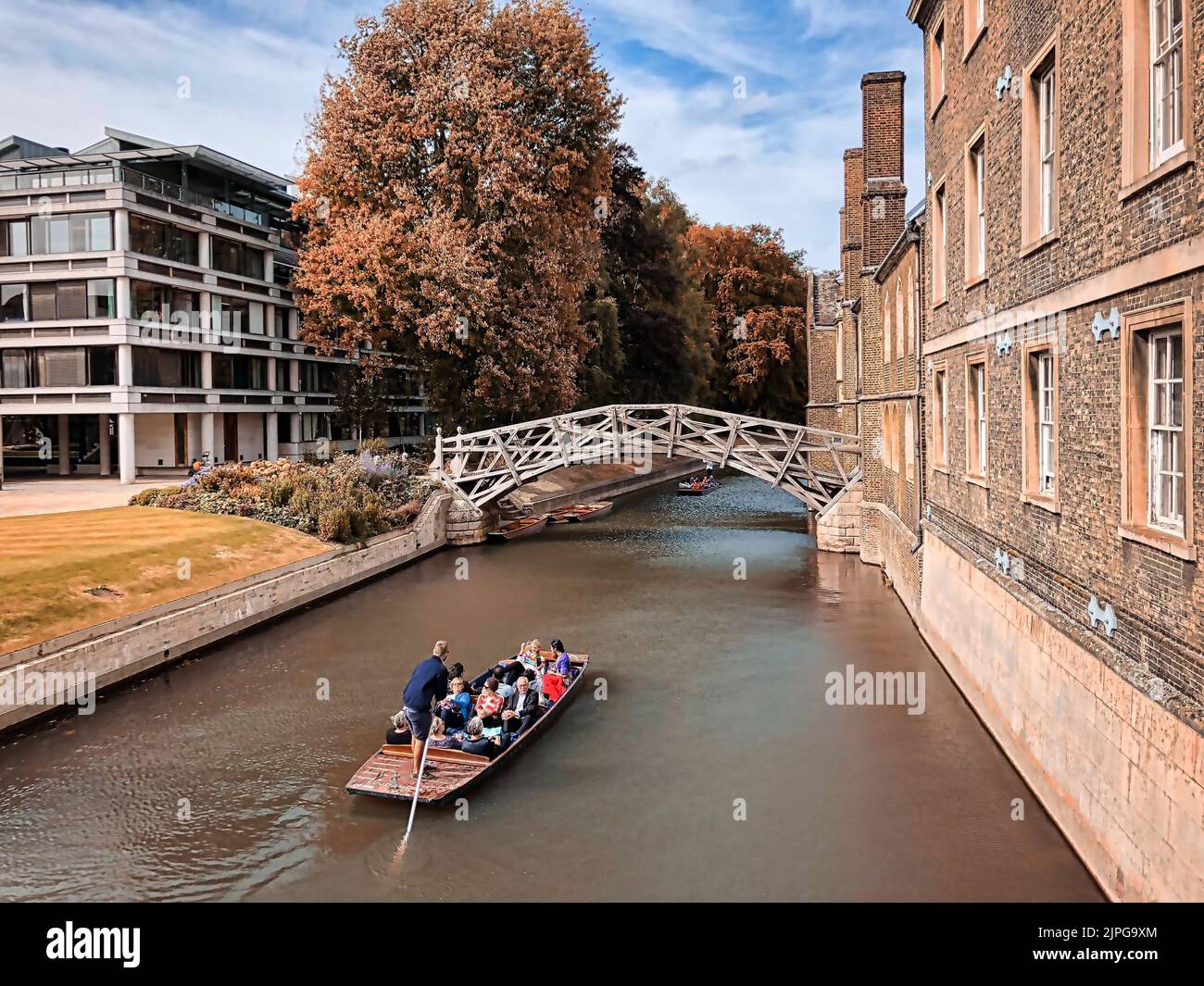 The Cambridge boat tour in a river against a scenic bridge in the United Kingdom Stock Photo