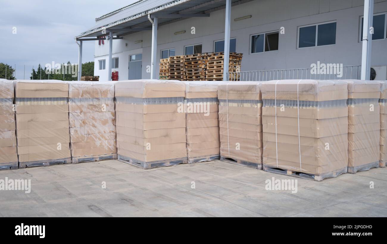 Rows of boxes and pallets in warehouse and production warehouse Stock