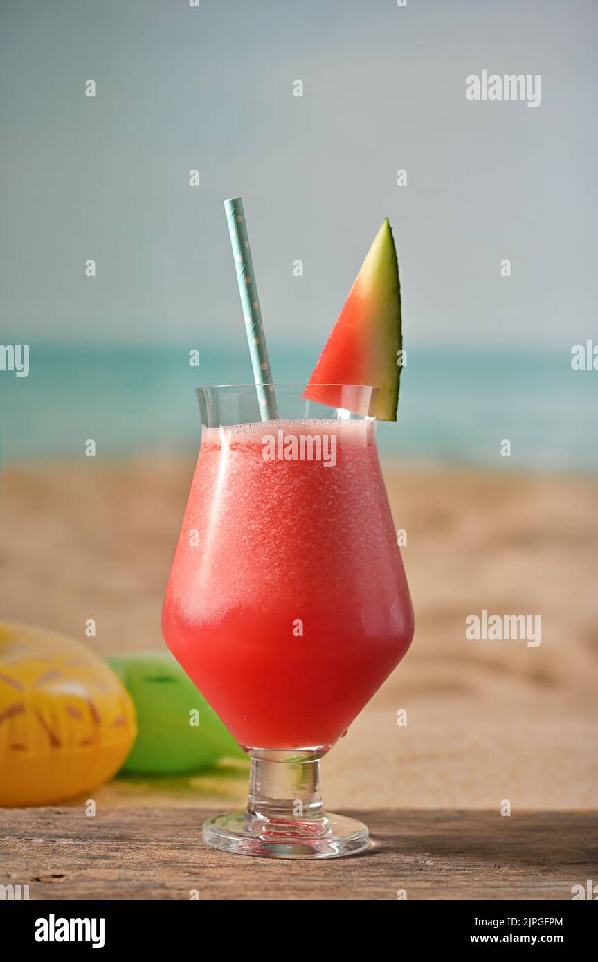 A Glass Of Freshly Squeezed Fresh Watermelon Juice on Beach Stock Photo