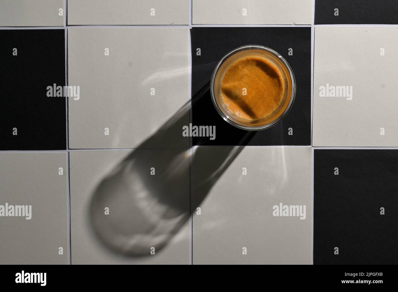 White And Black Square Tiled Paper and Espresso Cup with Shadow Stock Photo