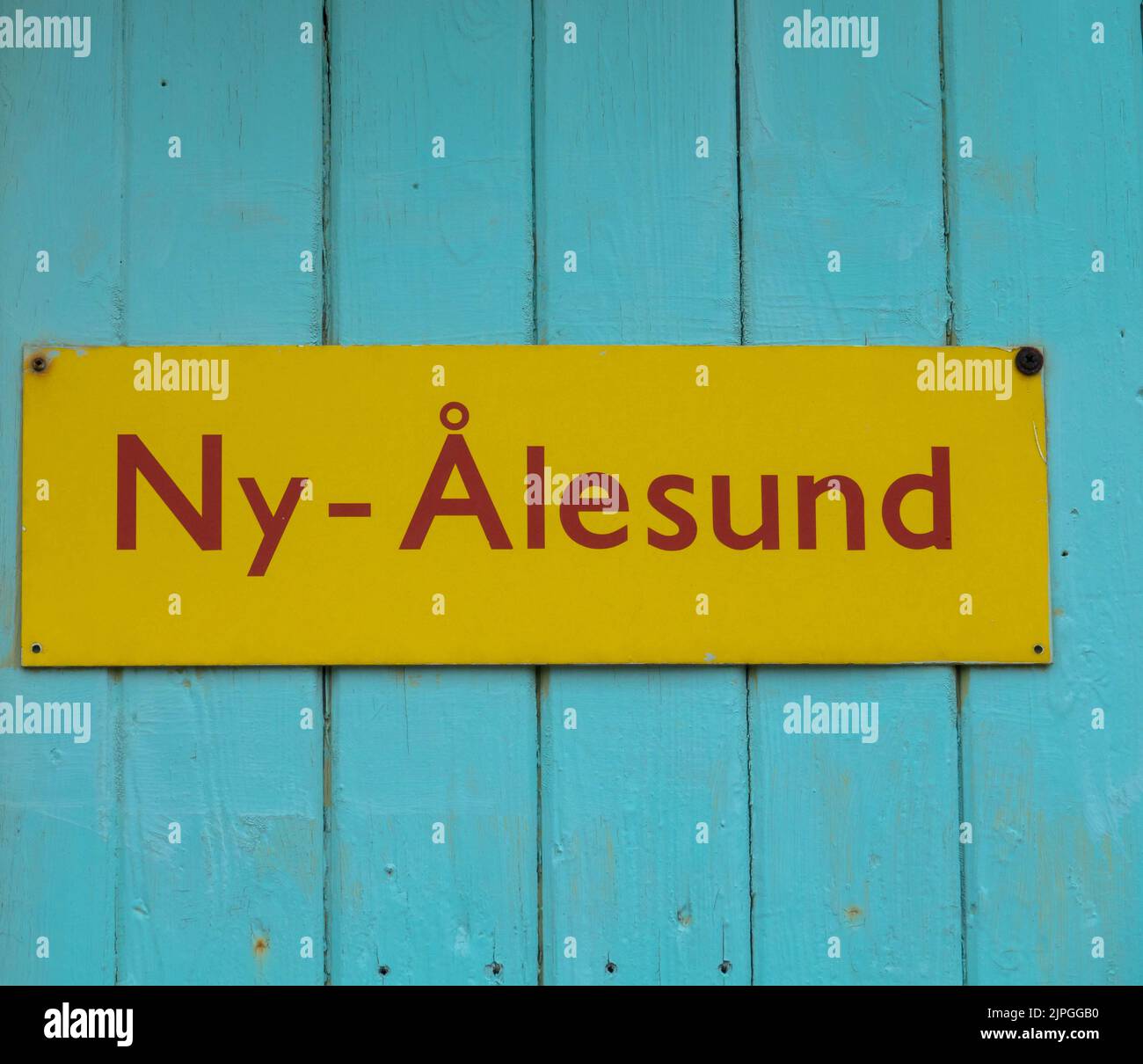 Yellow sign Ny-Alesund. close up. Tourism and vacation concept. Svalbard, Norway. Stock Photo