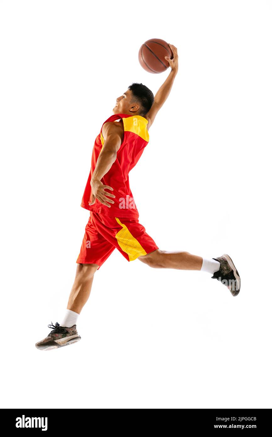 Portrait of young man, basketball player in motion, training isolated ...