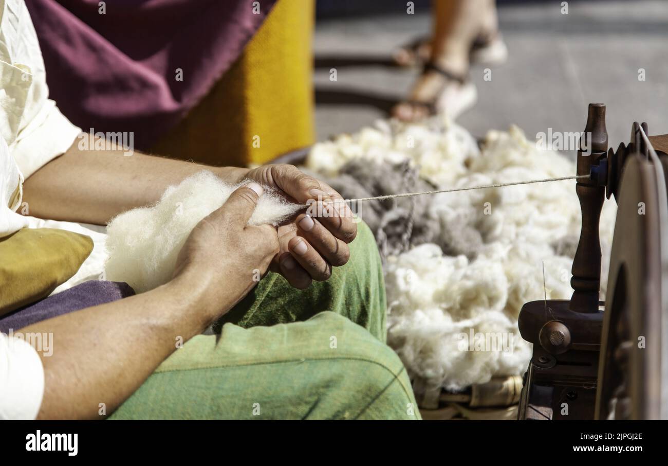 Detail of an old trade, spinning wool in an old and traditional way Stock Photo
