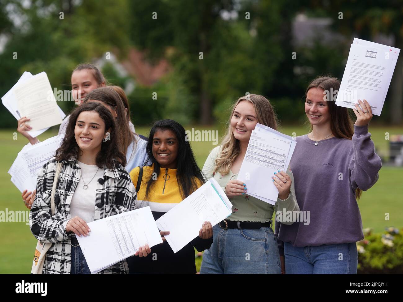 PIXELATION BY PA PICTURE DESK Former pupils of Strathearn Grammar School in east Belfast celebrate after receiving their A-level results. Picture date: Thursday August 18, 2022. Stock Photo