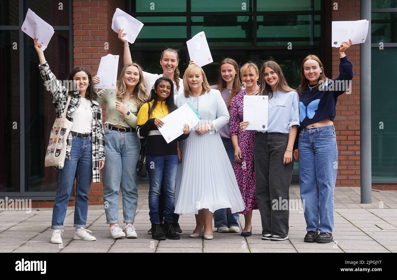 PIXELATION BY PA PICTURE DESK Education Minister Michelle McIlveen (centre) with former pupils of Strathearn Grammar School in east Belfast as they receive their A-level results. Picture date: Thursday August 18, 2022. Stock Photo