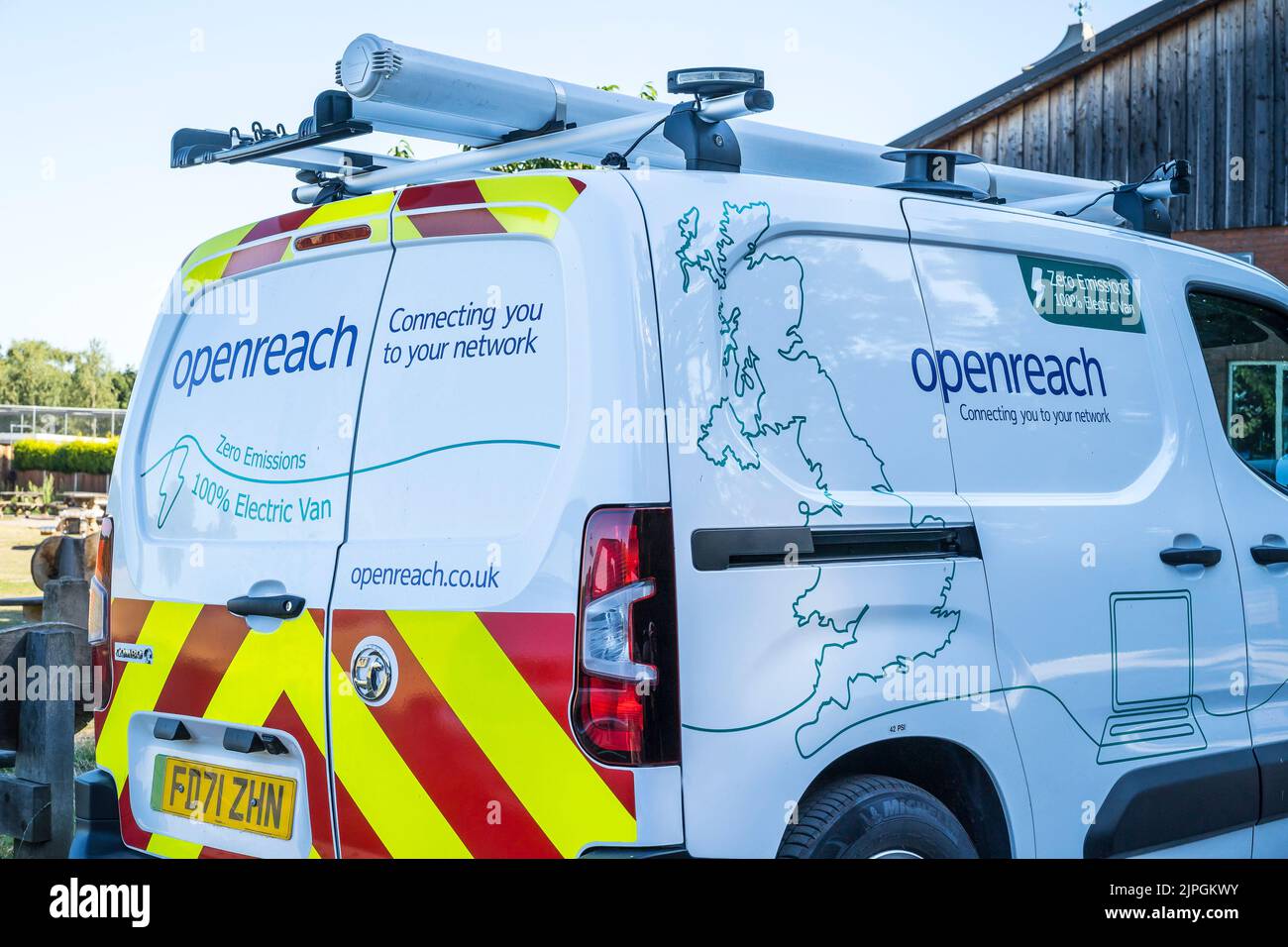 Rear & side of view of an Openreach, BT electric van with roof ladders isolated outdoors in UK