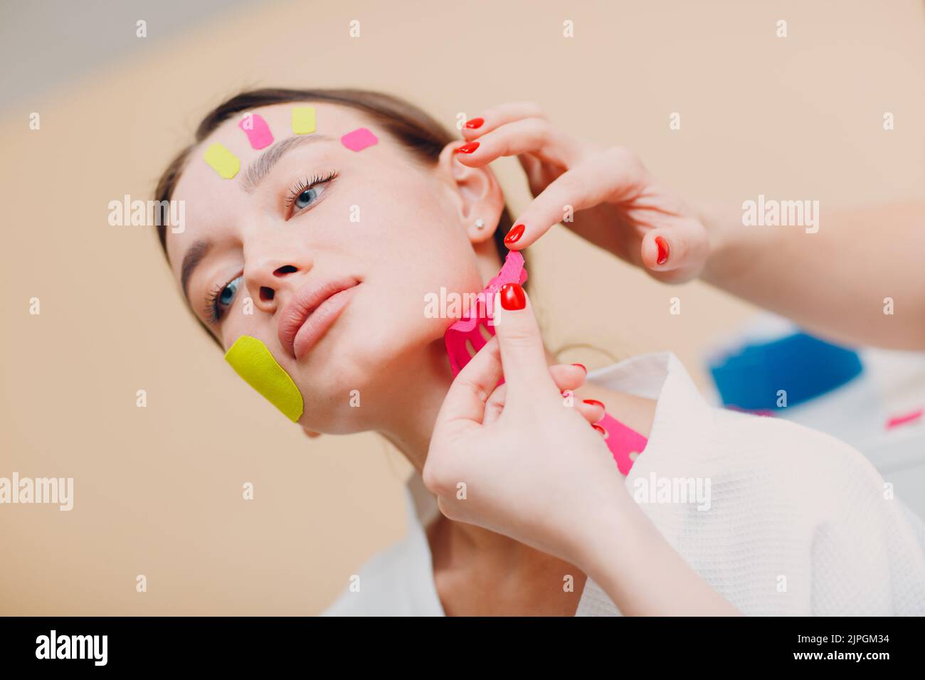 Beautiful woman applying tape lifting treatment procedure on face Stock Photo Alamy
