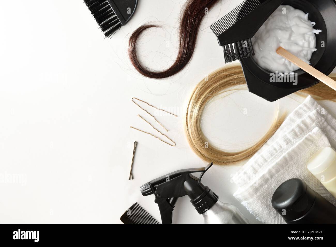 Set of hair care and coloring products from a stylist salon on white table. Top view. Horizontal composition. Stock Photo