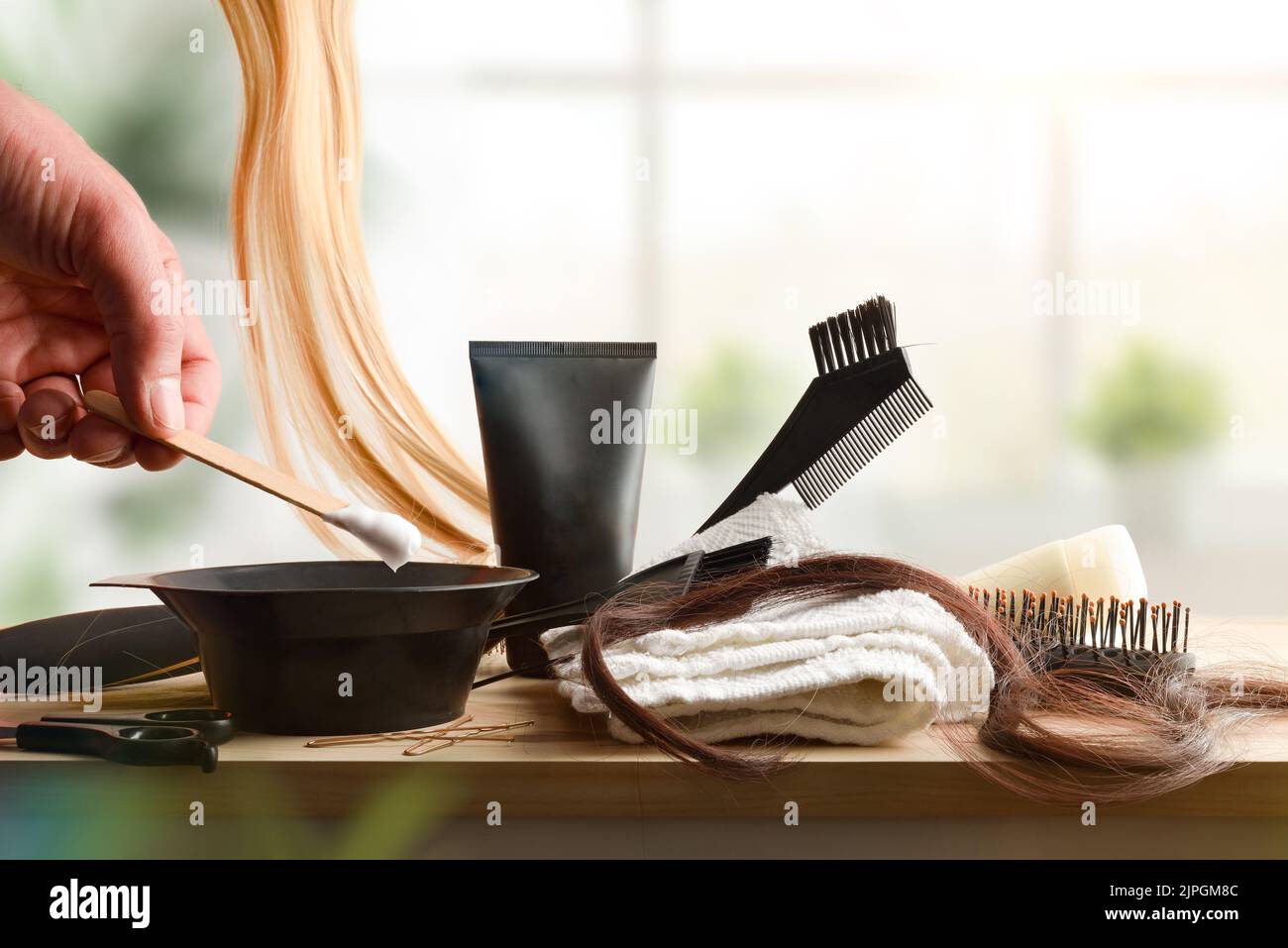 Set of hair treatment products on wooden table at home. Front view. Horizontal composition. Stock Photo