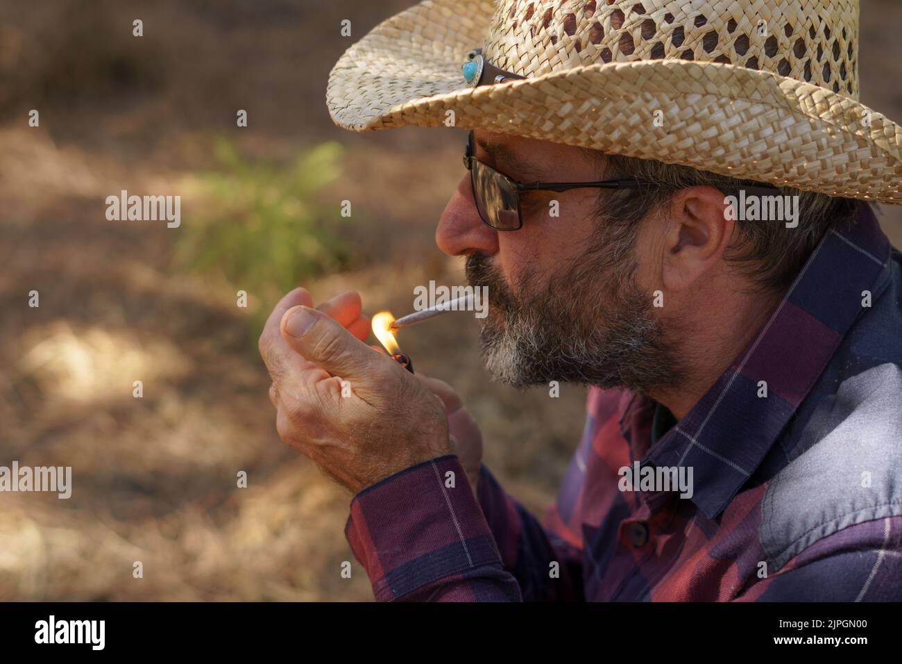 Cowboy lighting a cigarette hi-res stock photography and images