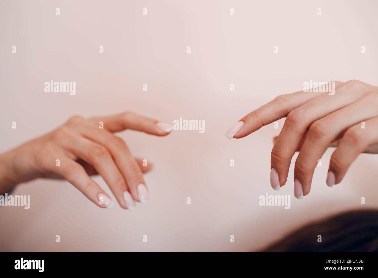 Female hand fingers nails with manicure after nail salon procedure