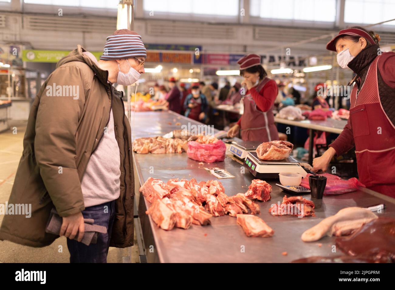 Adult man buying fresh meat at butchery market. Food shopping concept. Stock Photo