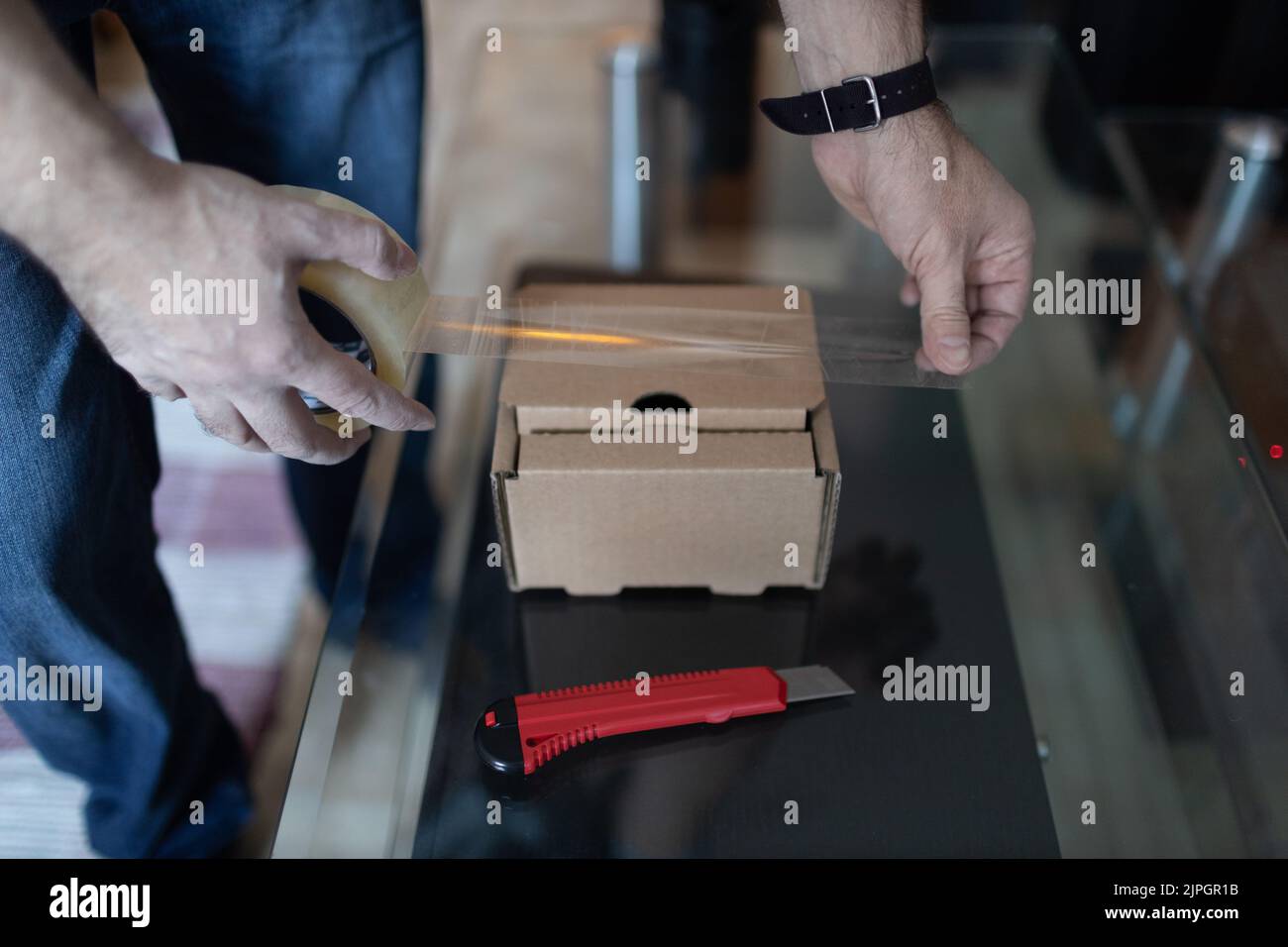 Adult man small business owner packing order box package shipping to ...