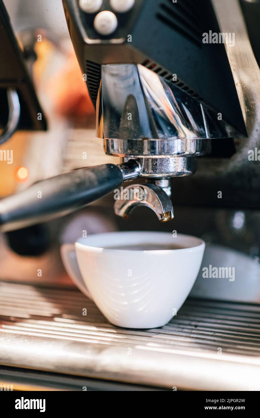 A Professional Stainless Steel Espresso Coffee Machine with a Freshly Made Cup of Espresso Stock Photo