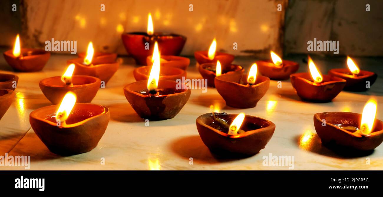 The traditional clay diya lamps lit during diwali celebration Stock Photo