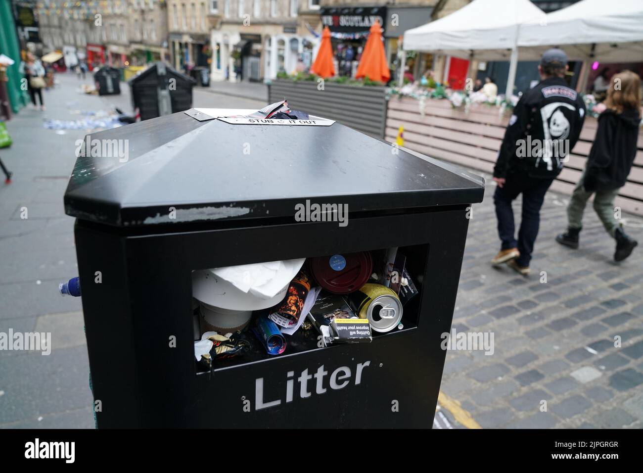 People pass an overflowing bin in Edinburgh city centre. Cleansing