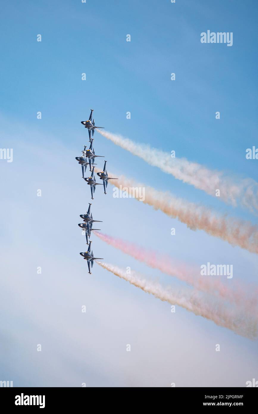 Eight Korean Air Force Golden Eagle Military Jet Trainers of the Black Eagles display team fly in extremely close formation while making a turn Stock Photo