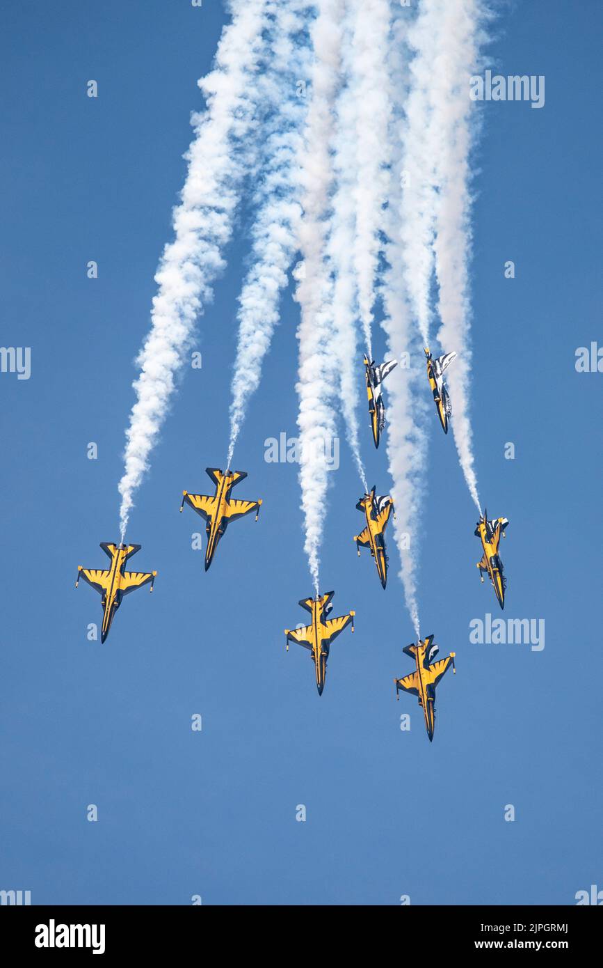 Eight Korean Air Force Golden Eagle Military Jet Trainers of the Black Eagles aerobatic display team dive down and break formation Stock Photo