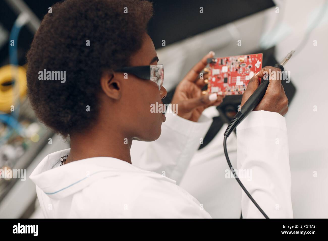 Scientist african american woman working in laboratory with soldering ...