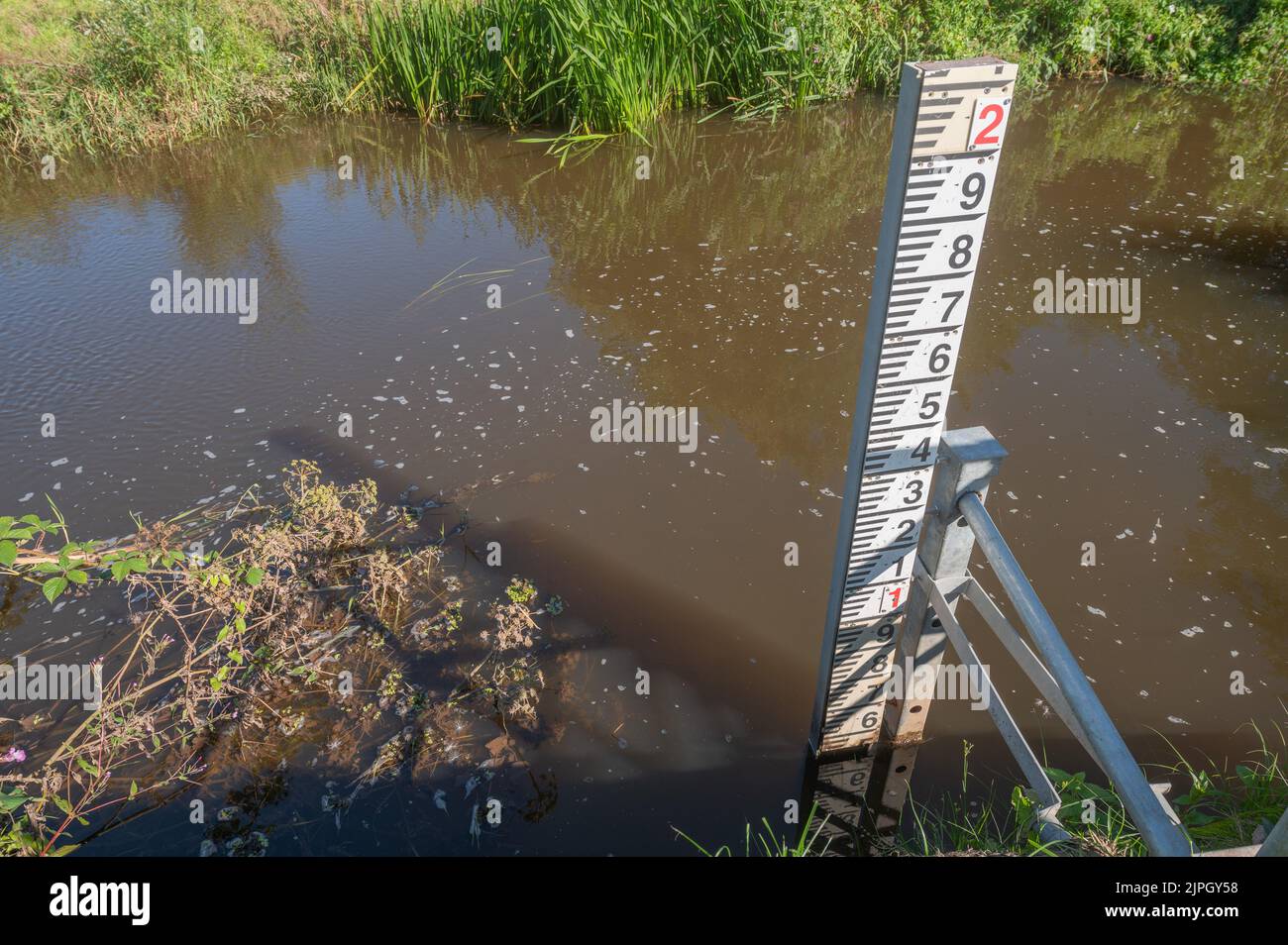 Low water level during the August 2022 drought showing on the river level gauging station on the Gwendraeth Fach at Llangyndeyrn, Carmarthenshire, Wal Stock Photo