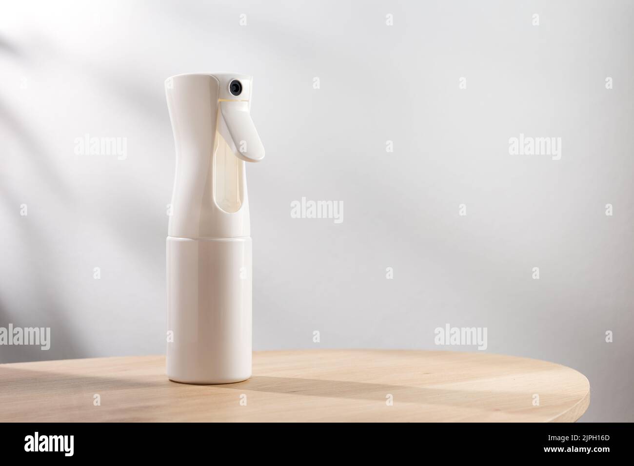 Alcohol spray bottle on a simple background Stock Photo - Alamy