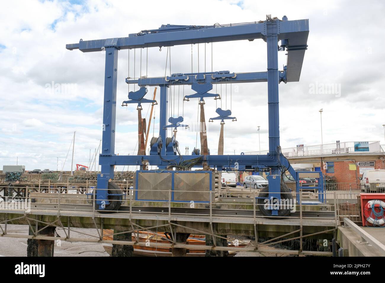 A huge boat lift dominates the harbour side views of Bridlington, Yorkshire. Stock Photo