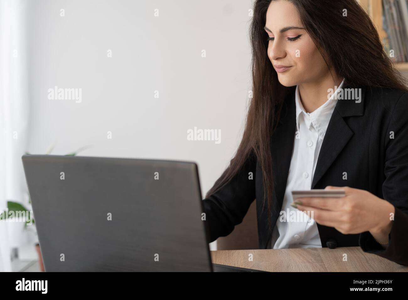 woman using credit card and laptop for buying online shopping working in office, online shopping payment Stock Photo