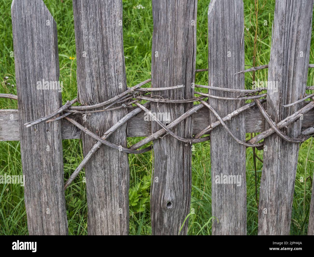The image is of woven saplings for Chestnut paling with not a nail-screw in sight of field boundary fencing as seen at Pertisau on Lake Achensee Stock Photo