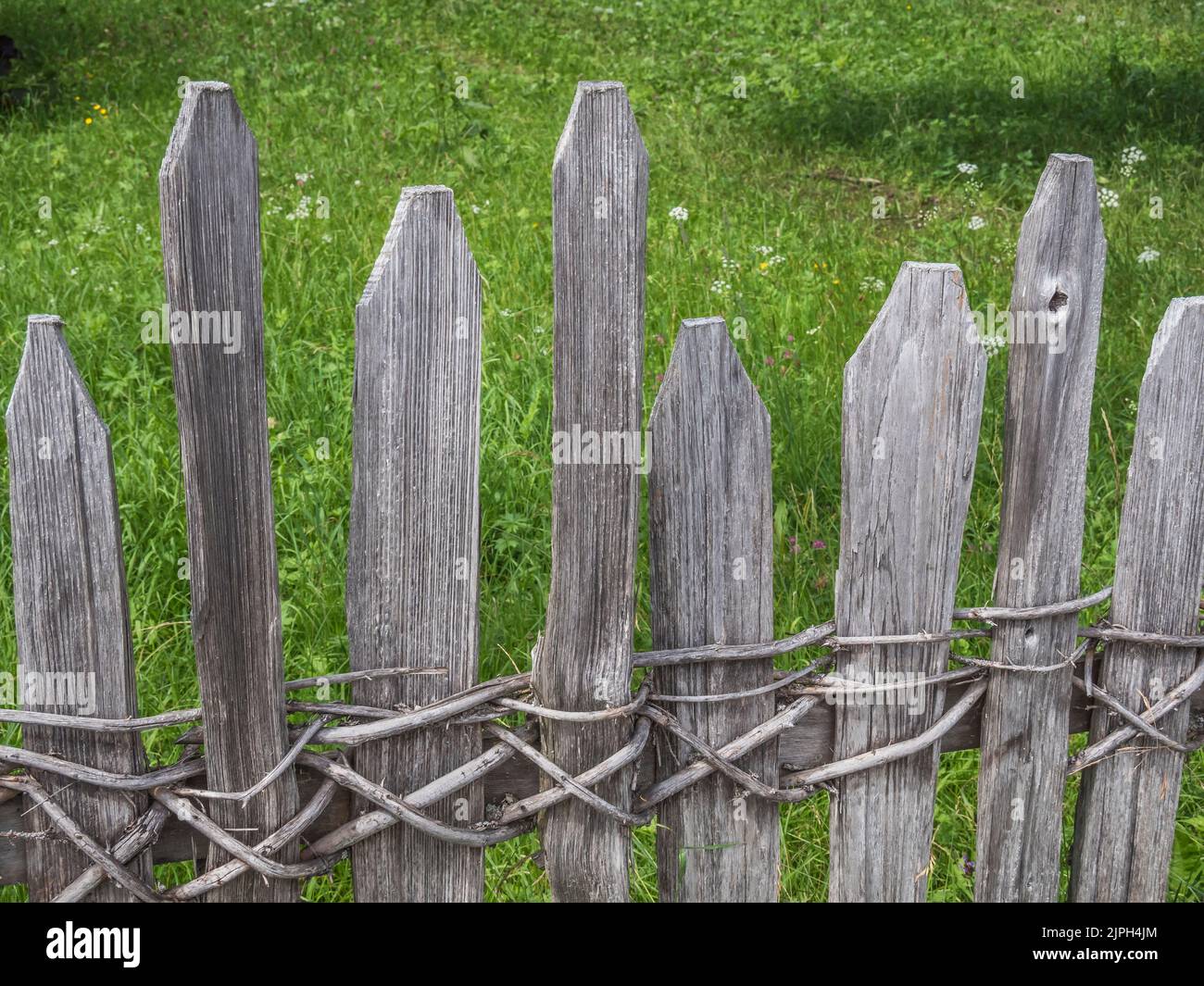 The image is of woven saplings for Chestnut paling with not a nail-screw in sight of field boundary fencing as seen at Pertisau on Lake Achensee Stock Photo