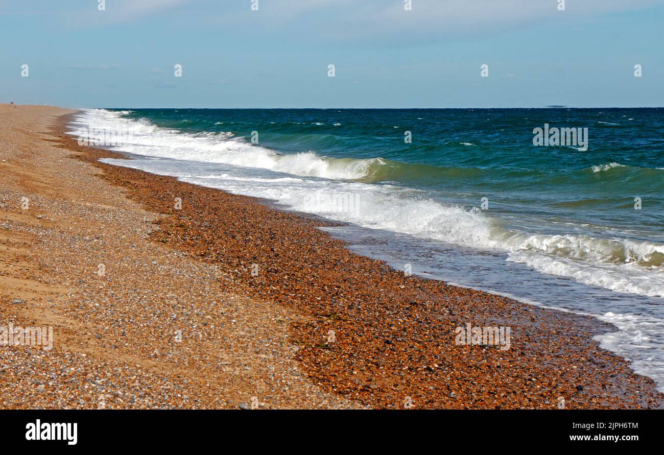 A view of the shingle beach and sea in summer on the North Norfolk coast towards Blakeney Point from Cley-Next-the-Sea, Norfolk, England, UK. Stock Photo
