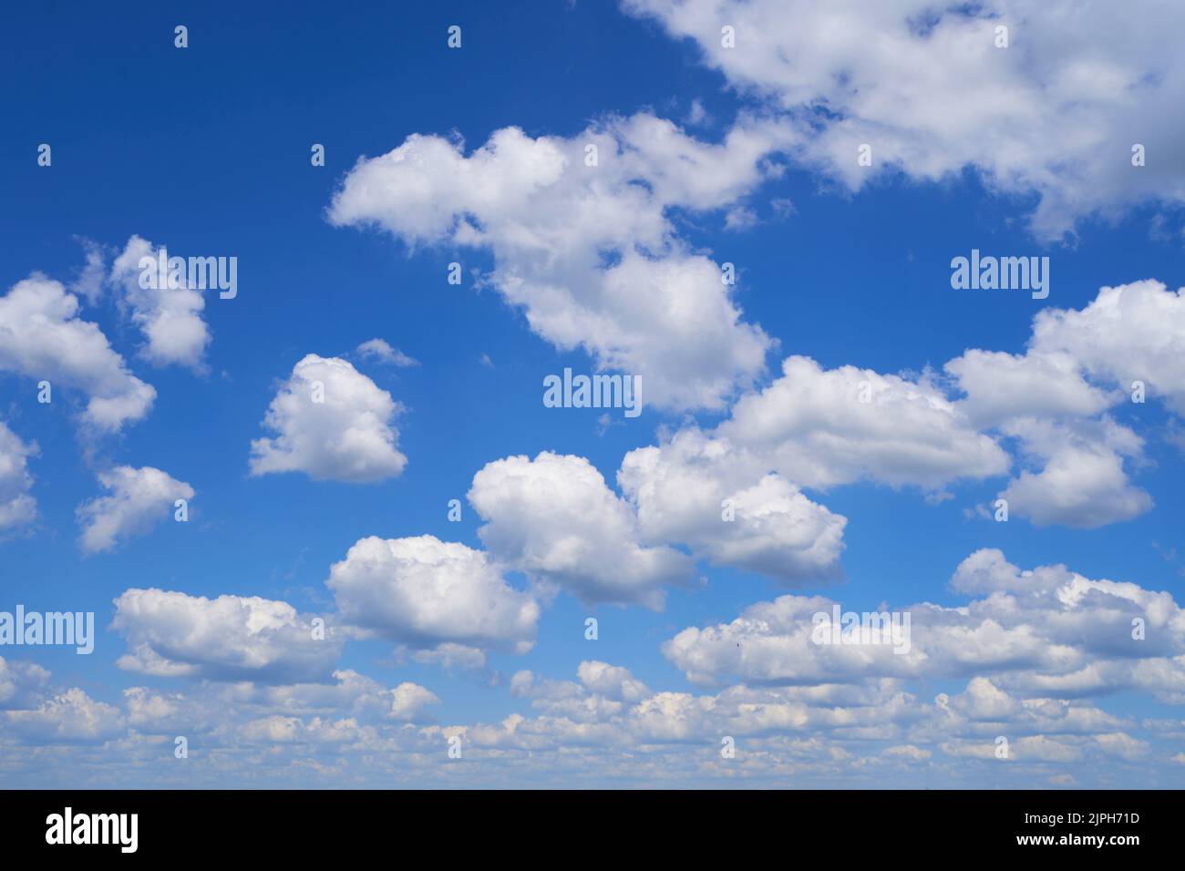 Fluffy clouds on blue sky in summer Stock Photo