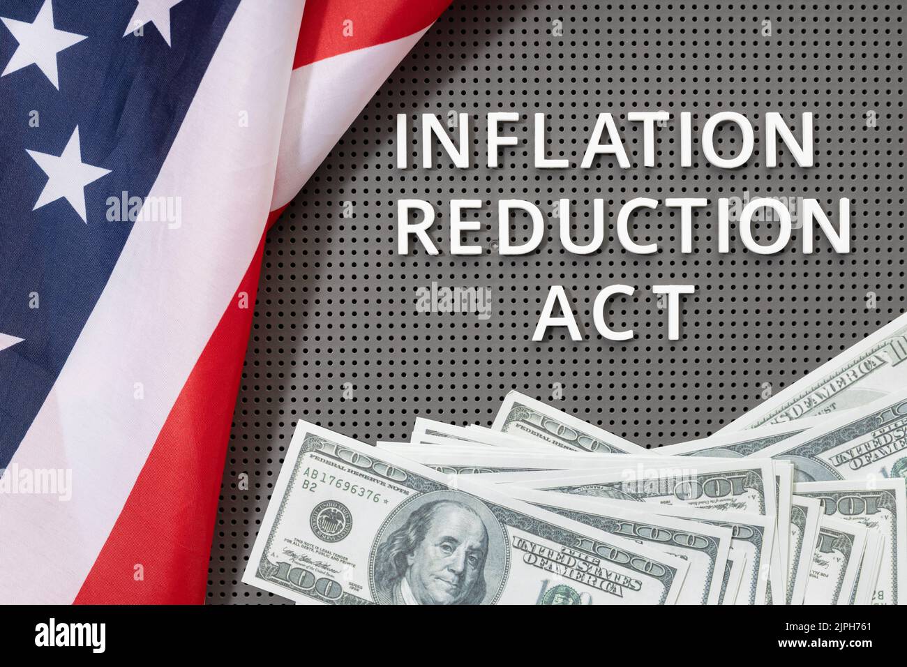 Inflation reduction Act law concept. Fat lay of text, american flag and